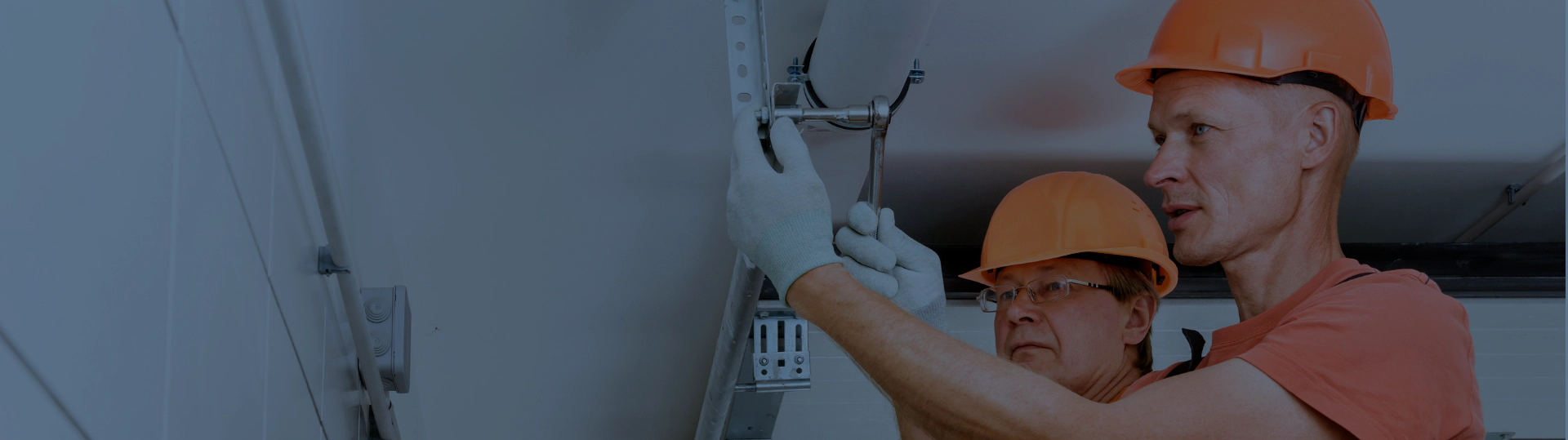 worker fixing the garage door